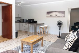 Luxury Apartment, Garden View | Living area | 21-inch TV with digital channels