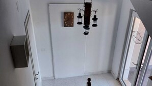 A staircase with wooden railings and a black and brown patterned rug at the bottom. - In the Green of Irpinia locality Montemarano (Avellino) stands Tenuta Casa Arsa. (Casa Arsa)