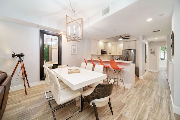 A modern kitchen with white cabinets, a stainless steel refrigerator, and a microwave. - Vacay Vibes at Mariners Club • Oceanfront Resort • Pools, Marina, Pickleball (Key Largo)
