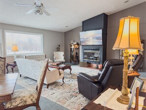 Smart TV, fireplace, books, computer monitors