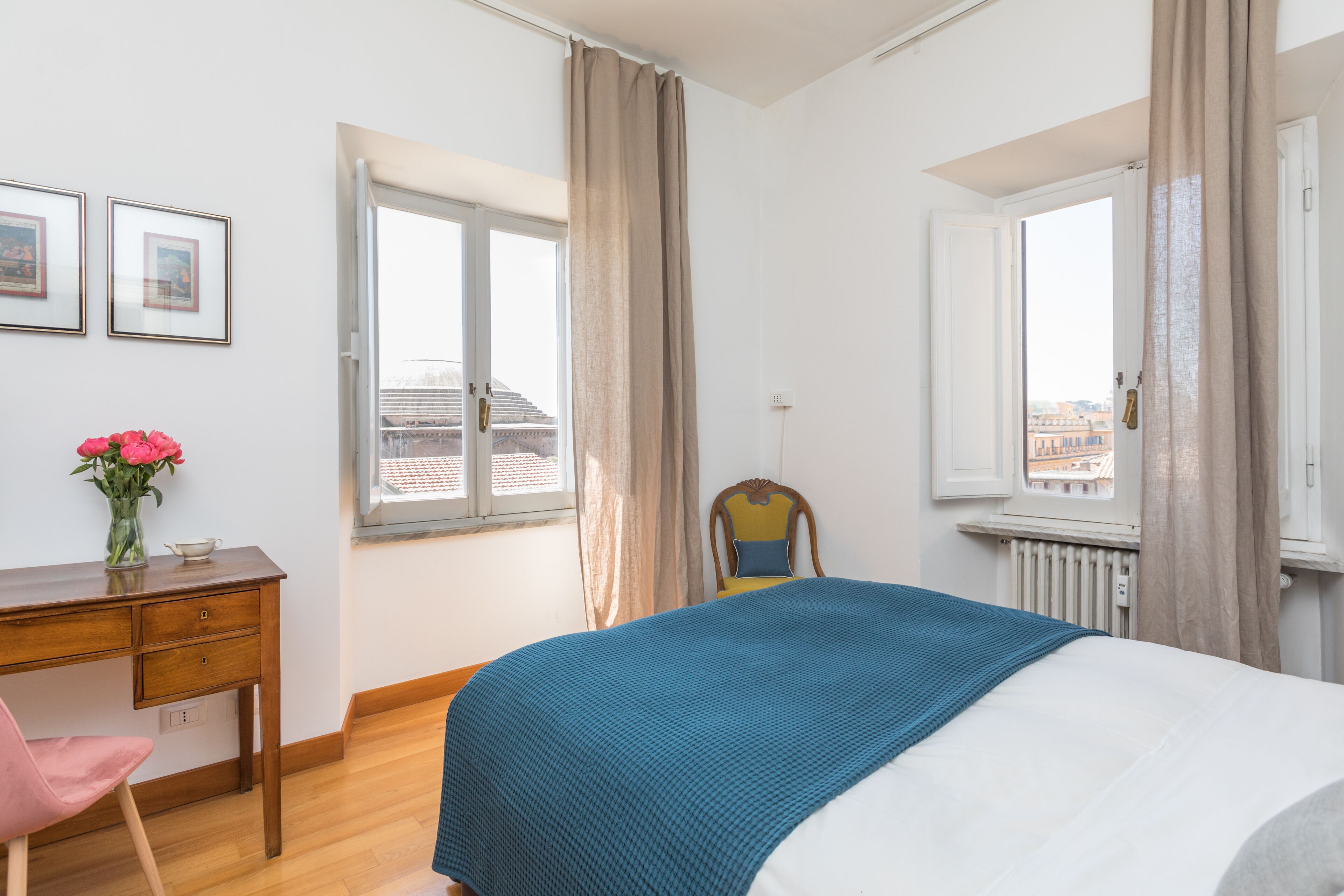 Une chambre à coucher comprenant un lit, un bureau, une chaise, une fenêtre et un radiateur.