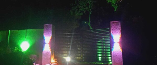 A gated entrance with vertical light fixtures and a reflective surface.