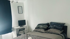 A bedroom with a bed, a desk, a chair, a TV, and a window. - Great family home to relax.
Within easy reach to London, Gatwick & Wimbledon . (Croydon)