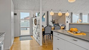 A modern kitchen with a wooden floor, white cabinets, and pendant lights. - Nice home in Lemvig with WiFi (Lemvig)