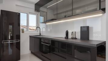 Comfort Apartment | Private kitchen | Full-sized fridge, microwave, oven, stovetop