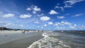 A beach with a clear sky and waves. - Updated Condo, Steps to Tennis + Pickleball Courts, Beach and Village, w/ a Pool (St. Simons Island)