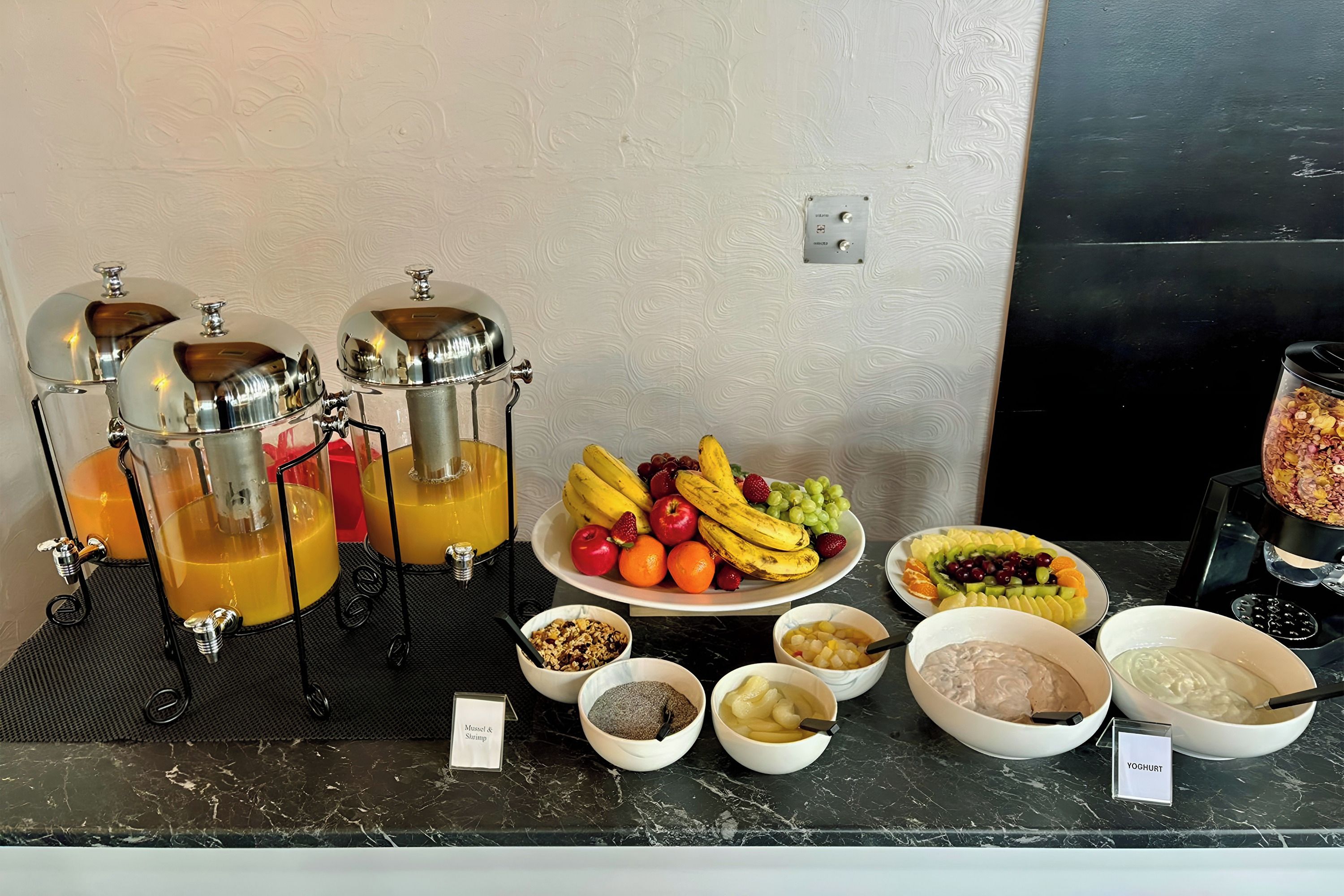 A buffet setup with various food items and a beverage station.