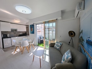 A modern apartment with a kitchen, dining area, and living room.