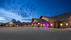 A building with a large parking lot and a covered entrance area.