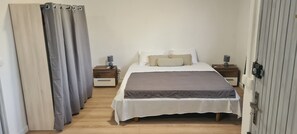 Cozy retreat with a large bed, bedside tables, and lamps.