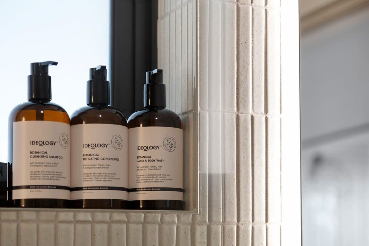 Three bottles of Ideology Botanical products on a shelf.