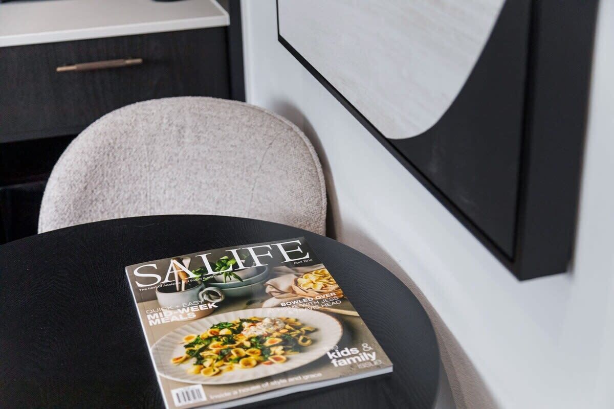 A magazine on a table with a black surface.