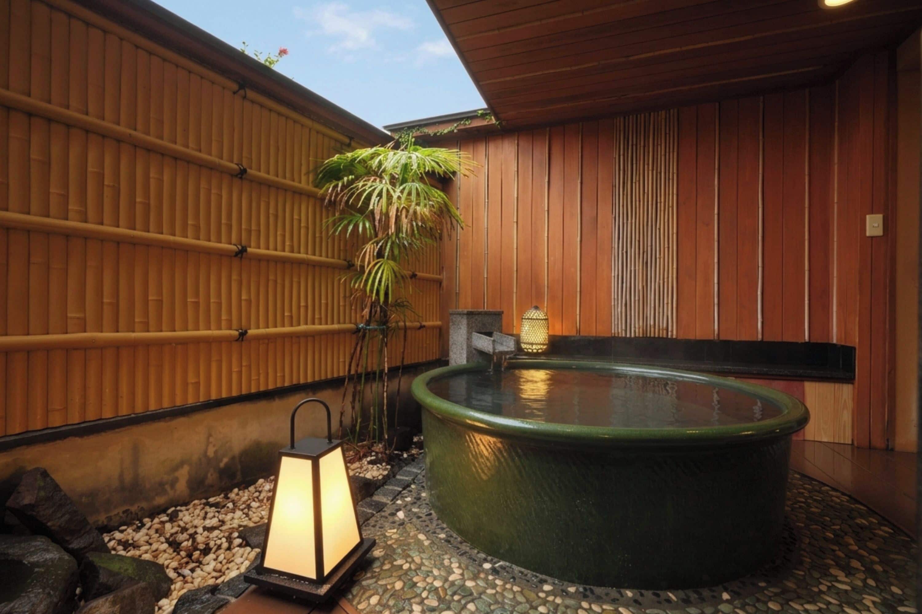 A hot tub with a wooden wall and a lantern.
