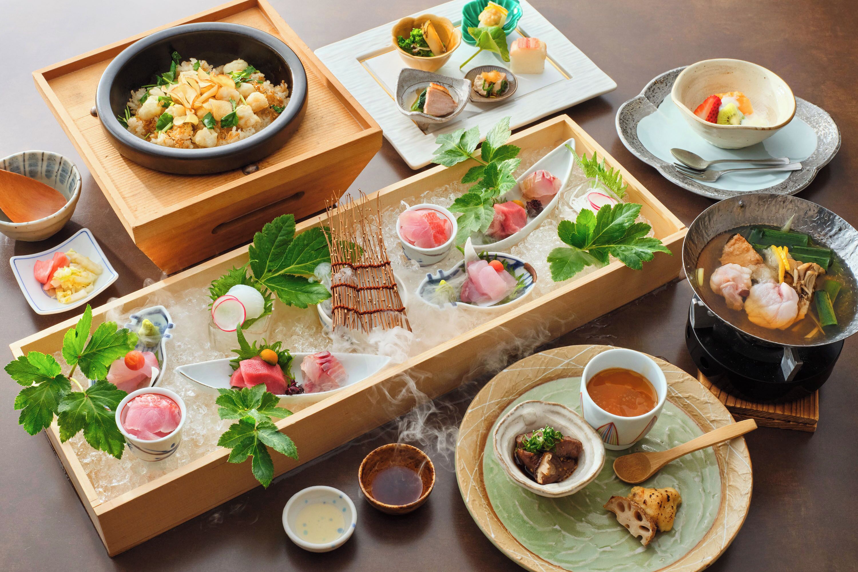 Una variedad de platos japoneses dispuestos en una bandeja de madera.