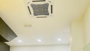 A modern kitchen with two computer monitors, a coffee machine, and a marble countertop. - Big Tree Hotel  (Temerloh)