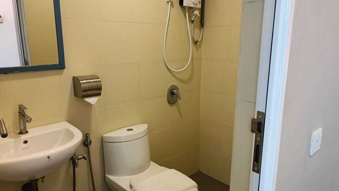 A small bathroom with a sink, toilet, and shower.