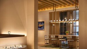 A modern hotel lobby with a reception desk, bar area, and seating. - Hampton by Hilton Shenzhen Science Park (Shenzhen)