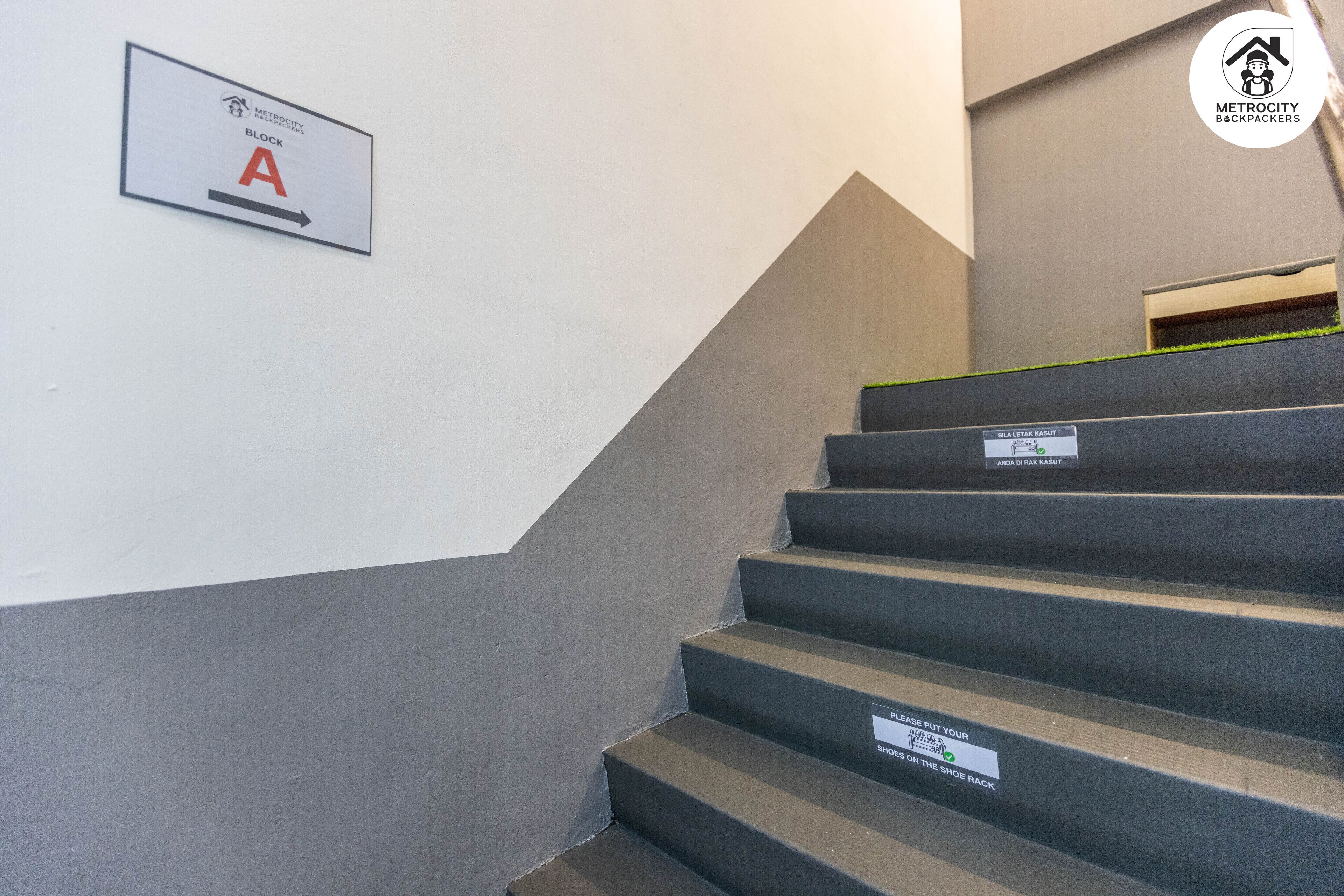 A staircase with a sign indicating direction to block A.