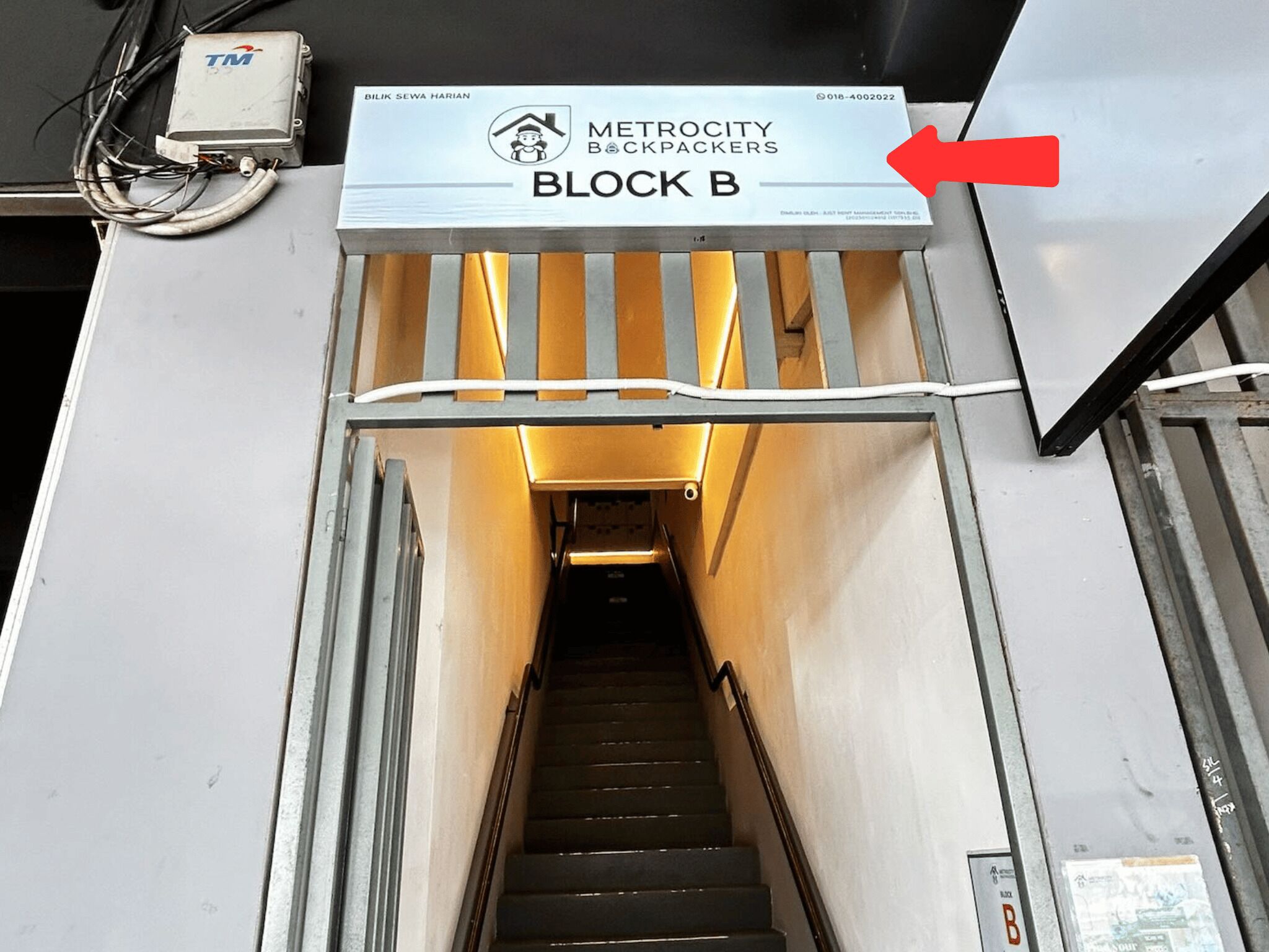 A stairwell leading to a block labeled 'METROCITY BACKPACKERS BLOCK B'.