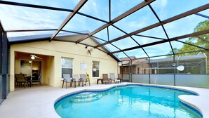 An indoor swimming pool with a glass ceiling, surrounded by lounge chairs and a table. - Fs3875ha - 4 Bedroom Villa In Sandy Ridge, Sleeps Up To 8, Just 6 Miles To Disney (Davenport)