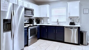A modern kitchen with white cabinets, stainless steel appliances, a built-in oven, and a dishwasher. - Fs3875ha - 4 Bedroom Villa In Sandy Ridge, Sleeps Up To 8, Just 6 Miles To Disney (Davenport)