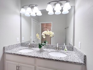 A bathroom with two sinks, a mirror, and a shower visible in the background. - Fs3986ha - 5 Bedroom Townhome In Champions Gate Resort, Sleeps Up To 10, Just 9 Miles To Disney (Davenport)