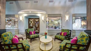 A spacious lobby with a central round table, patterned armchairs, and a glass display case. - Grh9372ha - Champions Gate Resort - 5 Bed 4 Baths Villa (Davenport)