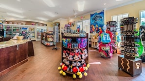 A store with shelves of snacks, a Mickey Mouse display, and a wall with a dolphin tapestry. - Grh9435ha - Windsor Palms Resort - 6 Bed 3.5 Baths Villa (Kissimmee)