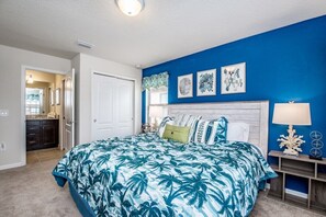A bedroom with a large bed, a nightstand, and a wall with framed artwork. - Fs9555ha - Windsor At Westside Resort - 7 Bed 5.5 Baths Villa (Kissimmee)
