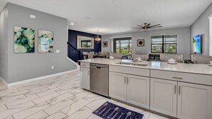 A spacious kitchen with a large island, modern appliances, and a view to the dining area. - Fs9867ha - Storey Lake Resort - 9 Bed 5 Baths Villa (Kissimmee)