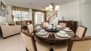 A dining area with a round table set for six, surrounded by six chairs. - Grh9167ha - Windsor Hills Resort - 6 Bed 4 Baths Villa (Kissimmee)