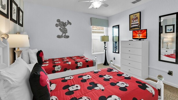A bedroom with two beds, a ceiling fan, a dresser, and a TV. - Grh9175ha - Windsor Hills Resort - 6 Bed 5 Baths Villa (Kissimmee)