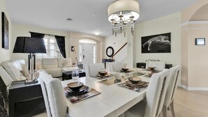 A dining area with a long table set for four, surrounded by chairs. - Grh9175ha - Windsor Hills Resort - 6 Bed 5 Baths Villa (Kissimmee)