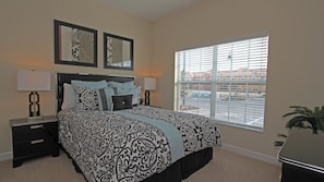A bedroom with a large bed, two bedside tables, and a window with blinds. - Grh9256ha - Paradise Palms Resort - 5 Bed 4 Baths Townhome (Kissimmee)