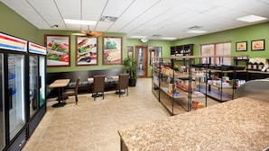 A restaurant with green walls, a counter with food items, and a seating area with tables and chairs. - Grh9256ha - Paradise Palms Resort - 5 Bed 4 Baths Townhome (Kissimmee)