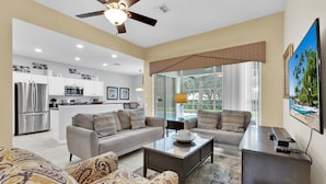 A modern living room with a sofa set, a coffee table, and a TV. - Grh9296ha - Windsor Hills Resort - 5 Bed 5 Baths Villa (Kissimmee)