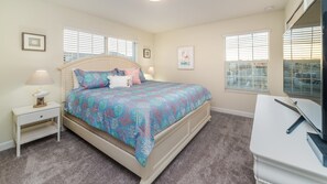 A bedroom with a bed, nightstand, dresser, and windows. - Grh10325ha - Champions Gate Resort - 5 Bed 4 Baths Townhome (Davenport)
