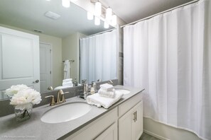 A bathroom with two sinks, a large mirror, and a shower curtain. - Fs10380ha - Champions Gate Resort - 4 Bed 3 Baths Townhouse (Davenport)