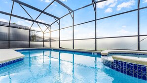 An indoor swimming pool with clear blue water, surrounded by a metal frame structure. - Fs11216ha - Emerald Island Resort - 5 Bed 4 Baths Villa (Kissimmee)
