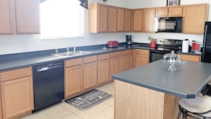 A modern kitchen with wooden cabinets, a dishwasher, a microwave, and a coffee maker. - Ffv11368ha - Windwood Bay - 5 Bed 4 Baths Villa (Davenport)