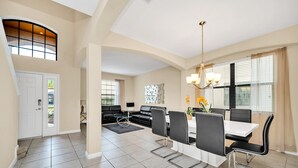 A spacious living area with a dining table, chairs, a sofa, and a chandelier. - Fs11379ha - Veranda Palms Resort - 6 Bed 4 Baths Villa (Kissimmee)
