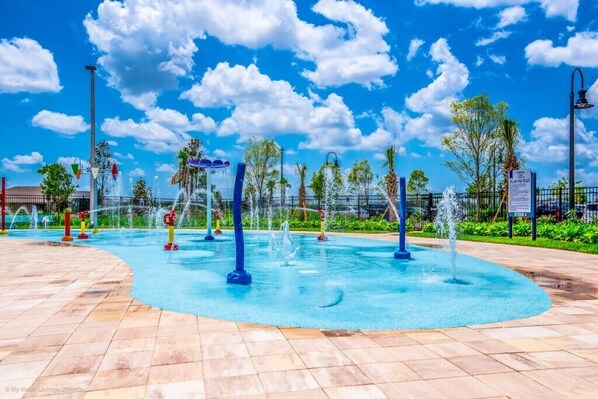 A water park with multiple water features and a clear blue sky.