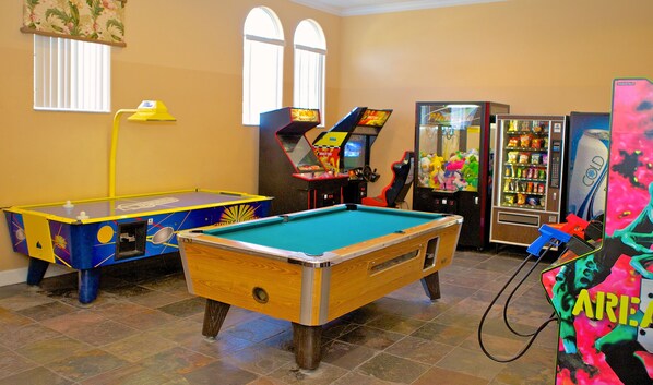 A pool table, a dartboard, and a vending machine in a room with tiled flooring and a window. - Ffv11400ha - Terra Verde Resort - 4 Bed 3 Baths Townhome (Kissimmee)