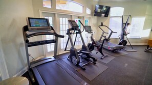 A gym with treadmills, elliptical machines, and a stationary bike. - Grh11487ha - Emerald Island Resort - 7 Bed 5.5 Baths Villa (Kissimmee)
