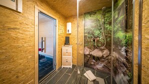 A modern bathroom with a glass shower, wooden walls, and a digital clock. - Country Mill between Moselle and Hunsrück (Bernkastel-Kues)