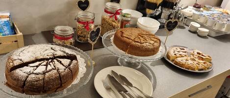 A breakfast buffet with various food items and utensils.