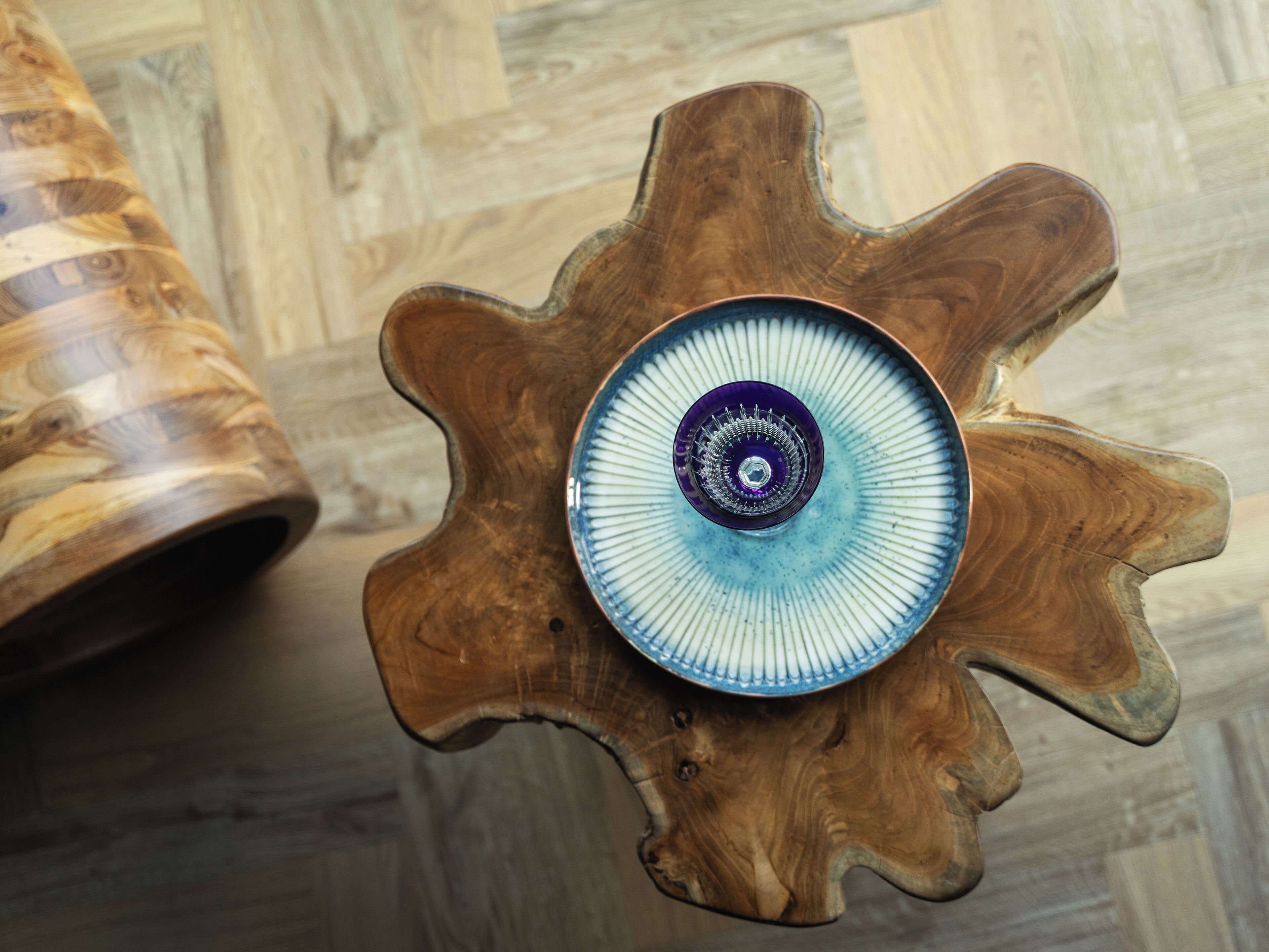 A wooden table with a blue and white patterned bowl on top.
