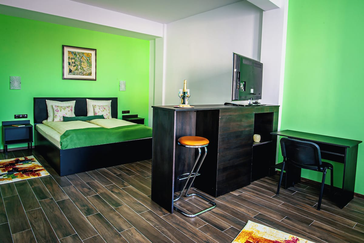 A modern room with a bed, a desk, and a chair.