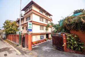 A two-story hotel with a sign indicating it is a hotel. - Hotel Harmony Bistro (Lalitpur)