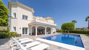 A large house with a swimming pool, outdoor seating, and a well-maintained garden. - Villa Panorama  (Oliva)